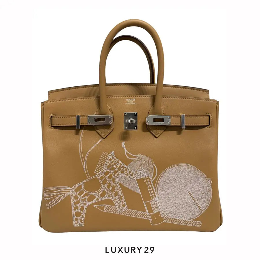 Brown handbag with intricate design on a white background