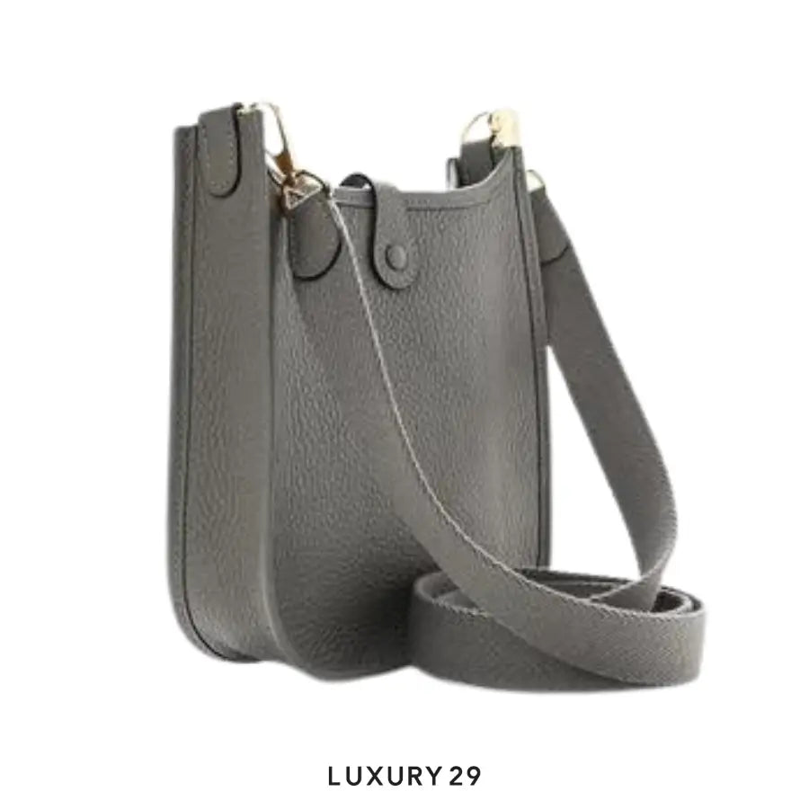 Gray handbag with a strap on a white background