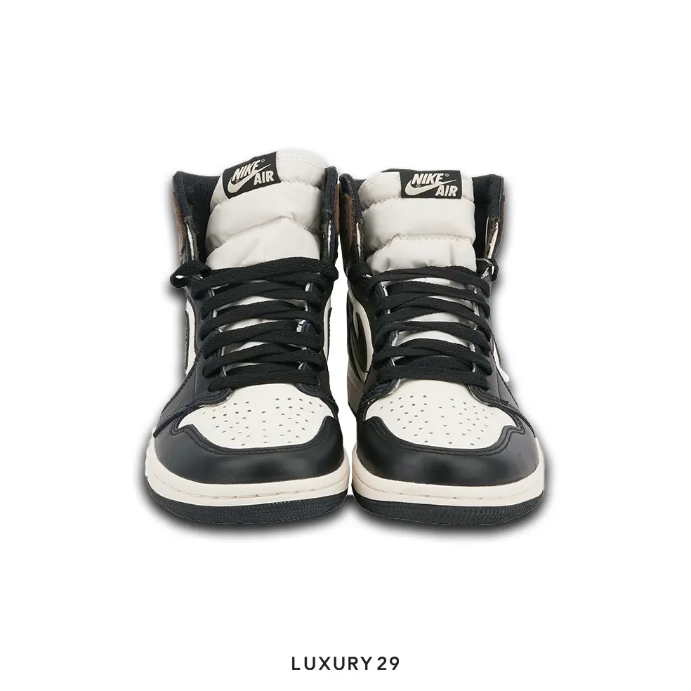 Black and white high-top sneakers with Nike Air logo on a white background