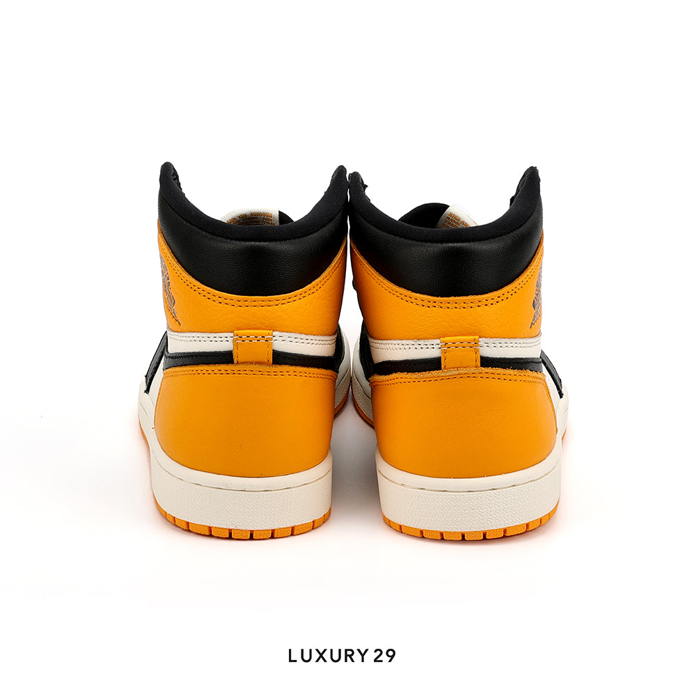 Pair of orange high-top sneakers with black and white accents on a white background