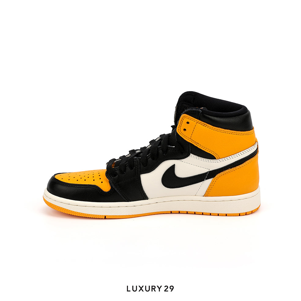 Black and orange high-top sneaker with a white sole on a white background
