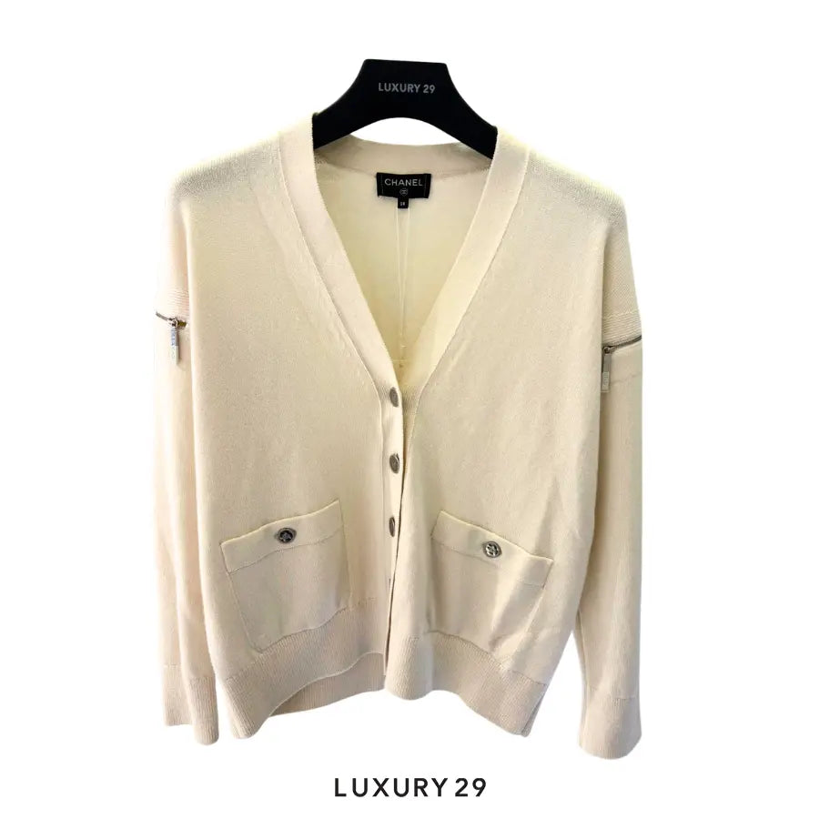 Chanel white knit cardigan V-neck front pockets with snap button closures and zipper accents on the shoulders/sleeves