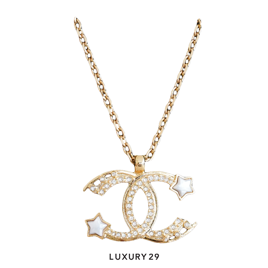 Gold necklace with a CC pendant on a white background