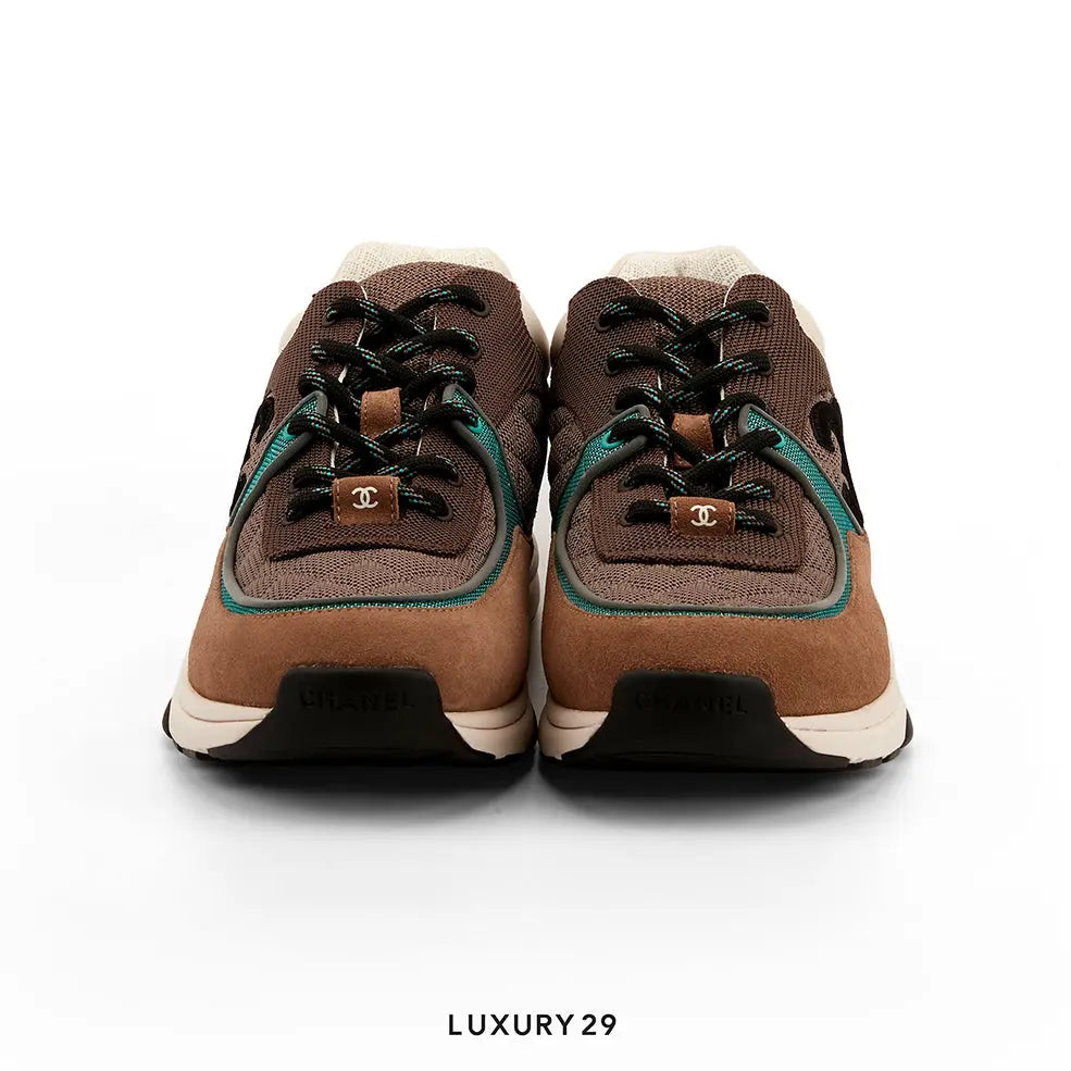 Brown sneakers with black laces on a white background, featuring the brand logo.