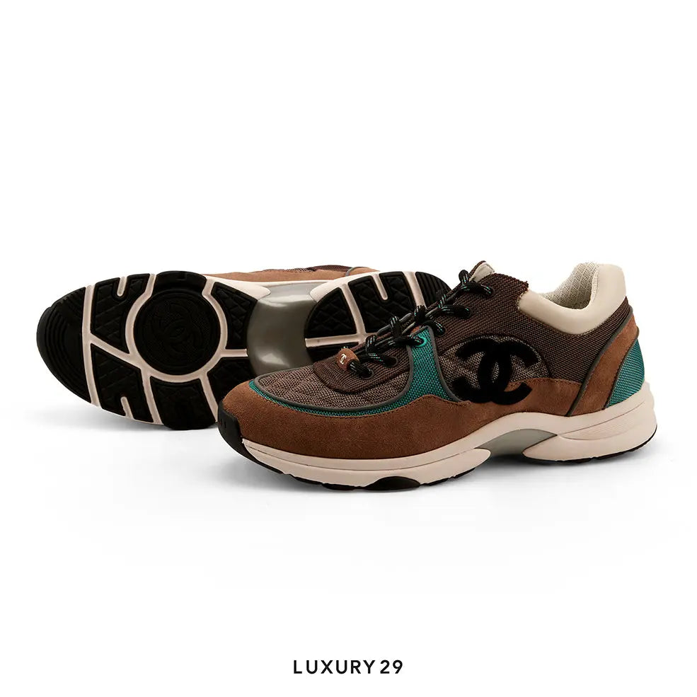 Brown and teal sneaker with black logo on a white background