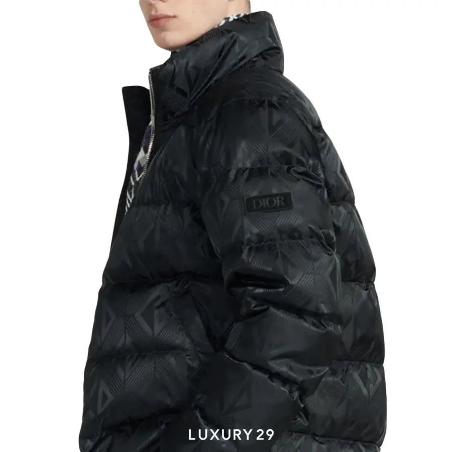 Black puffer jacket with a brand logo on a white background