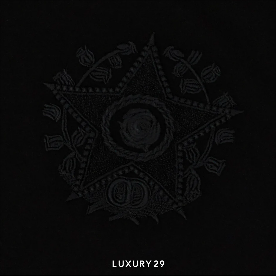 Decorative black emblem with intricate designs on a black background, featuring the text 'LUXURY29'.