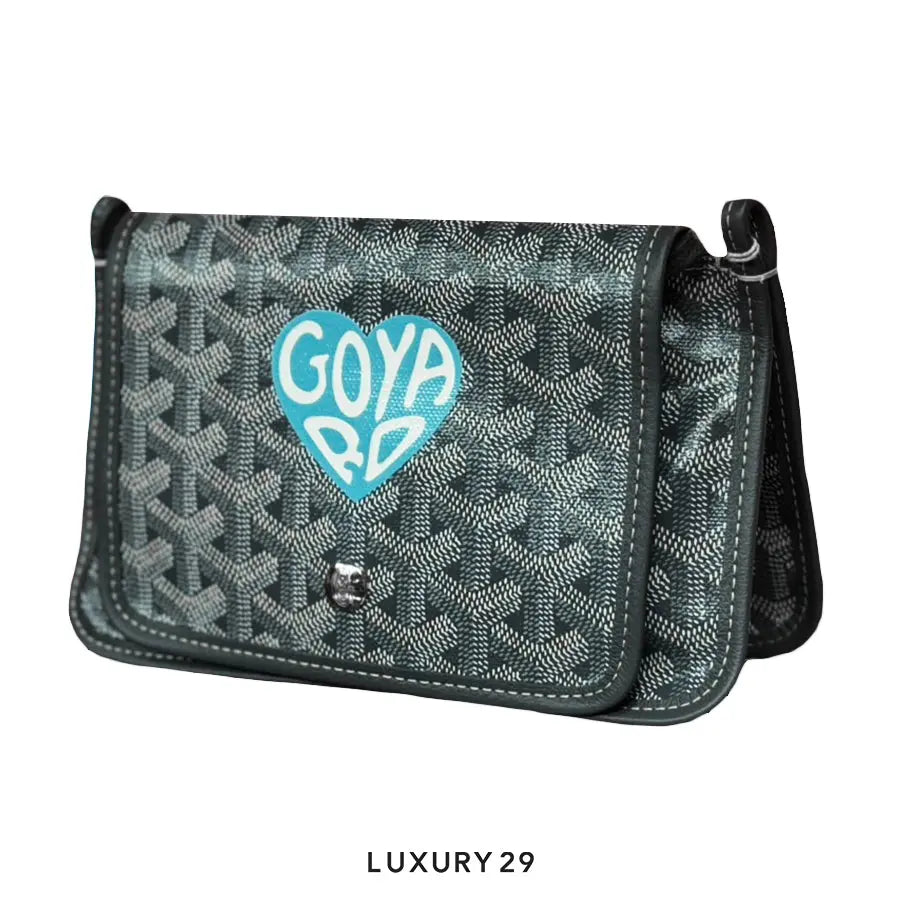 Patterned handbag with 'Goya' logo on a white background