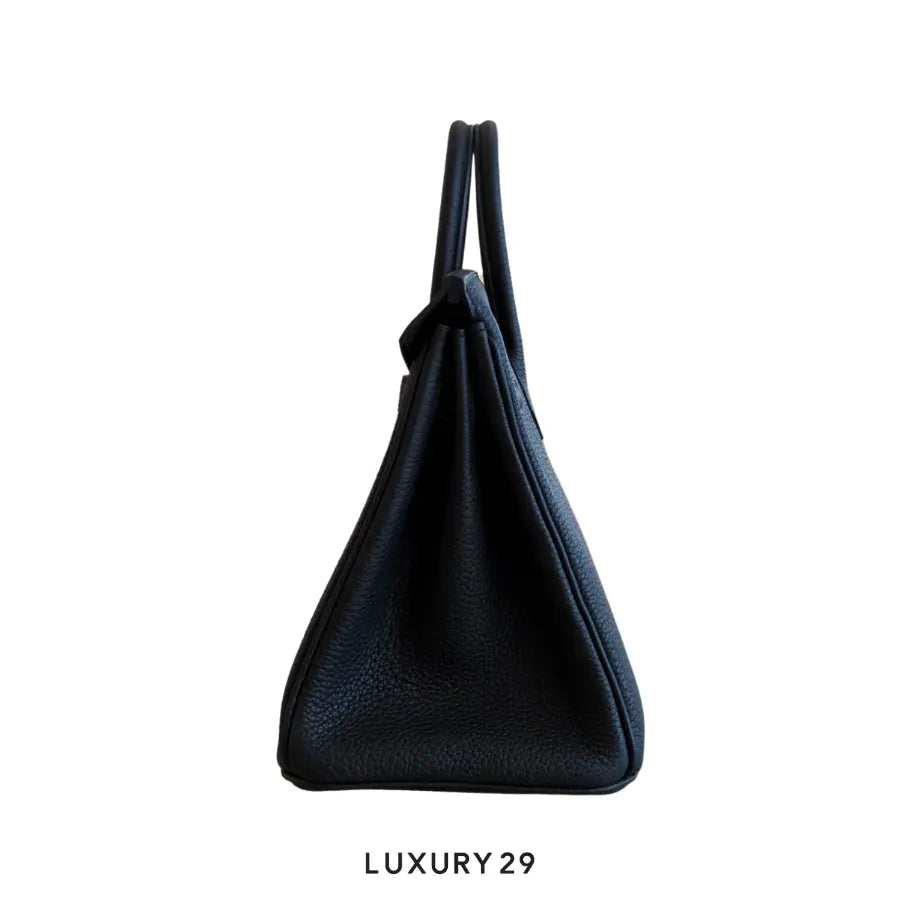 Black handbag on a white background with 'LUXURY 29' text.