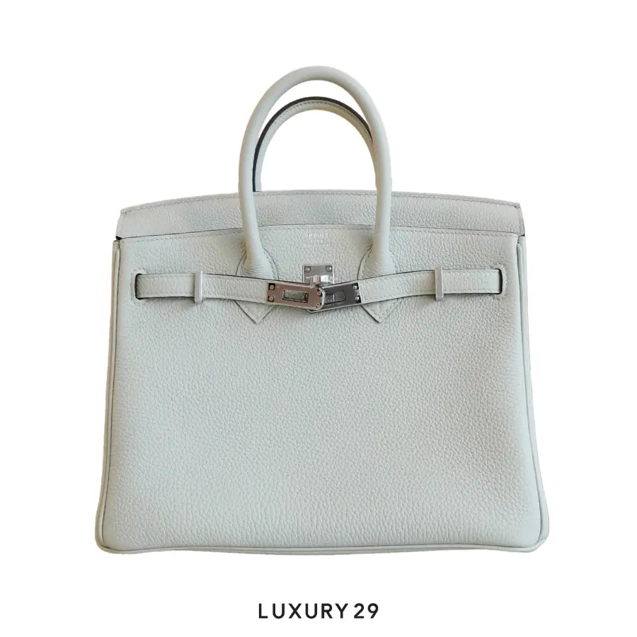 White handbag with silver hardware on a white background