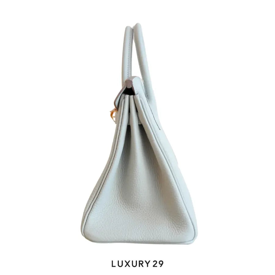 White handbag on a white background with 'LUXURY 29' text.
