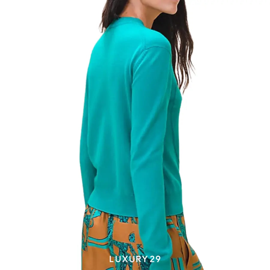 Teal long-sleeve top worn by a person on a white background with 'LUXURY 29' branding.