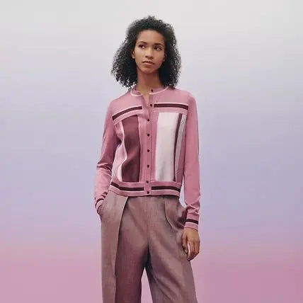 Woman wearing a pink and white patterned cardigan on a gradient background