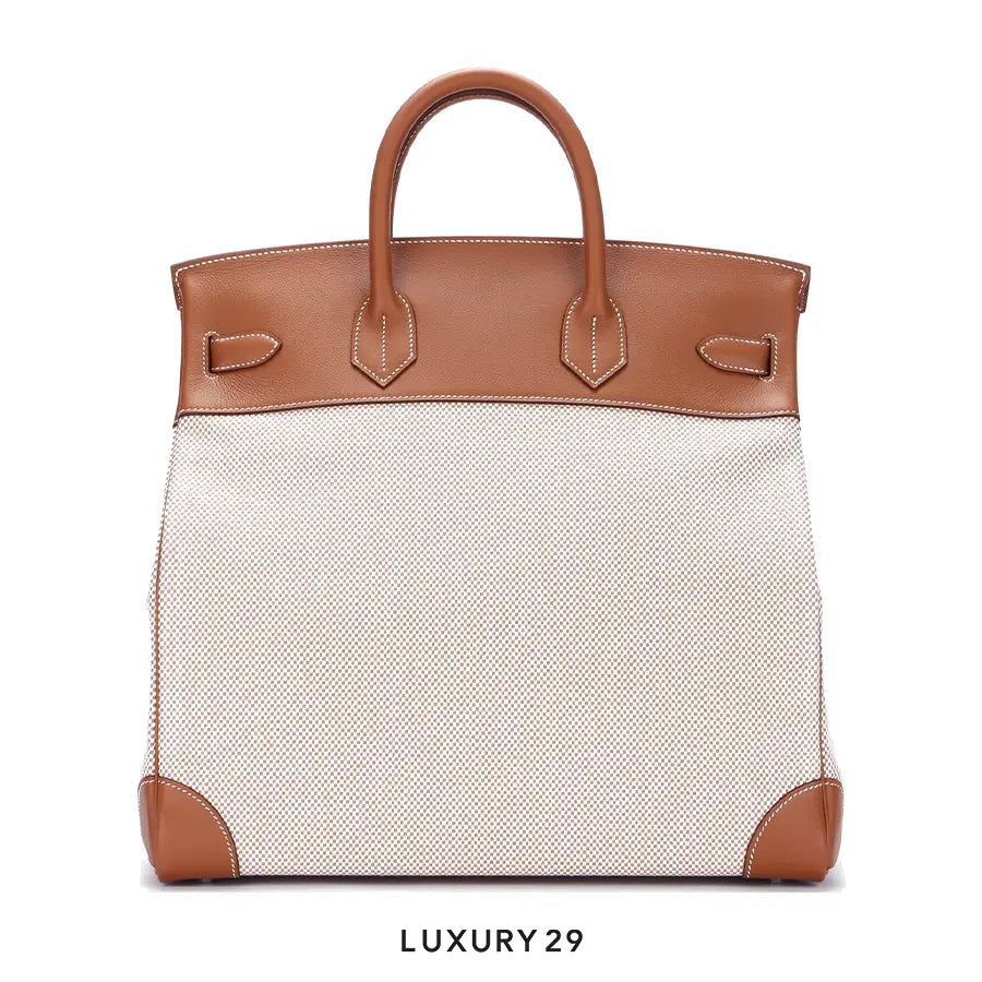 Luxury handbag with brown leather accents on a white background