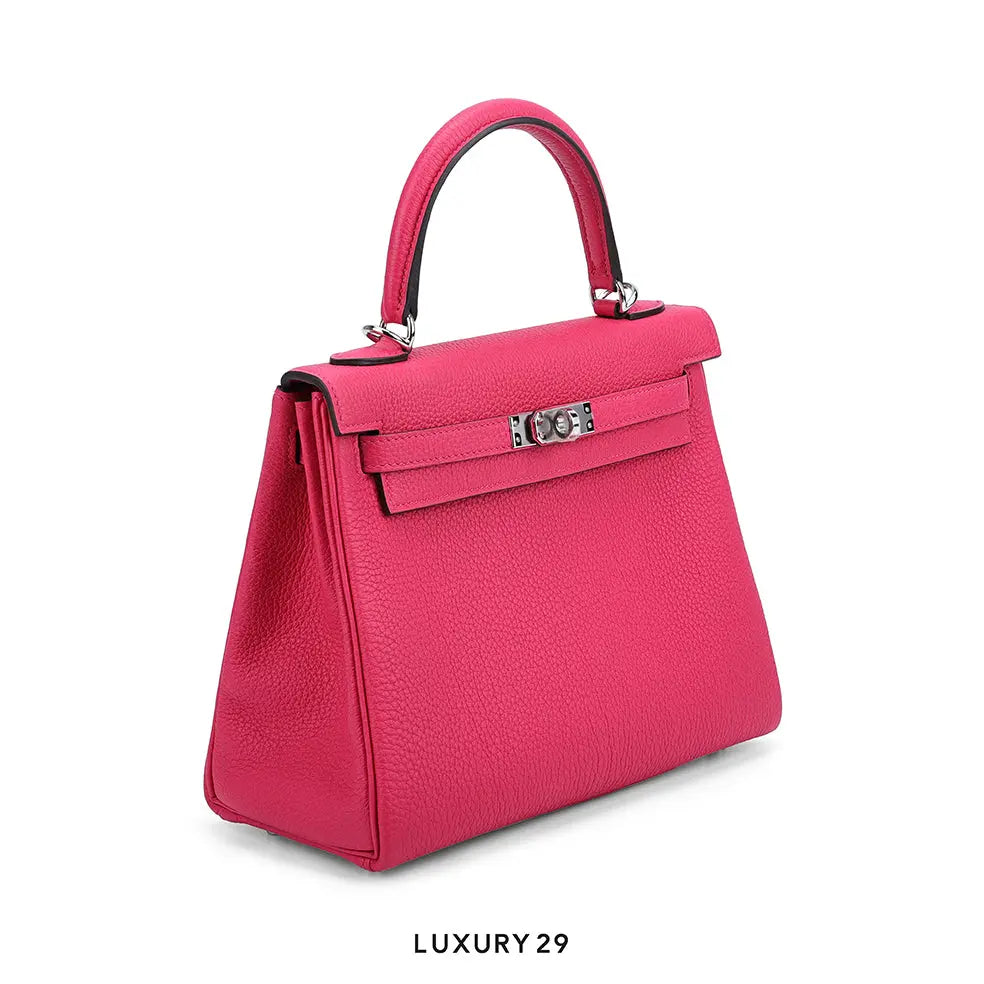Pink handbag with a silver clasp on a white background