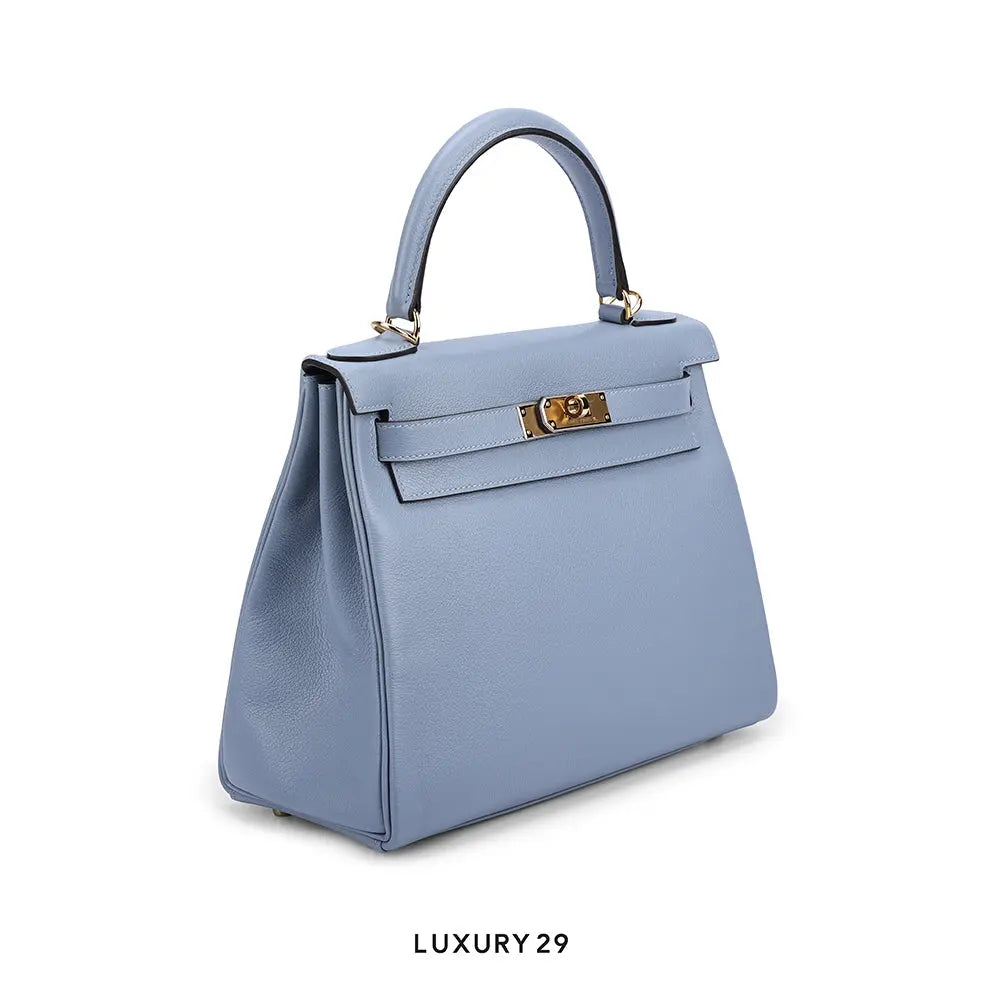 Blue handbag with gold hardware on a white background