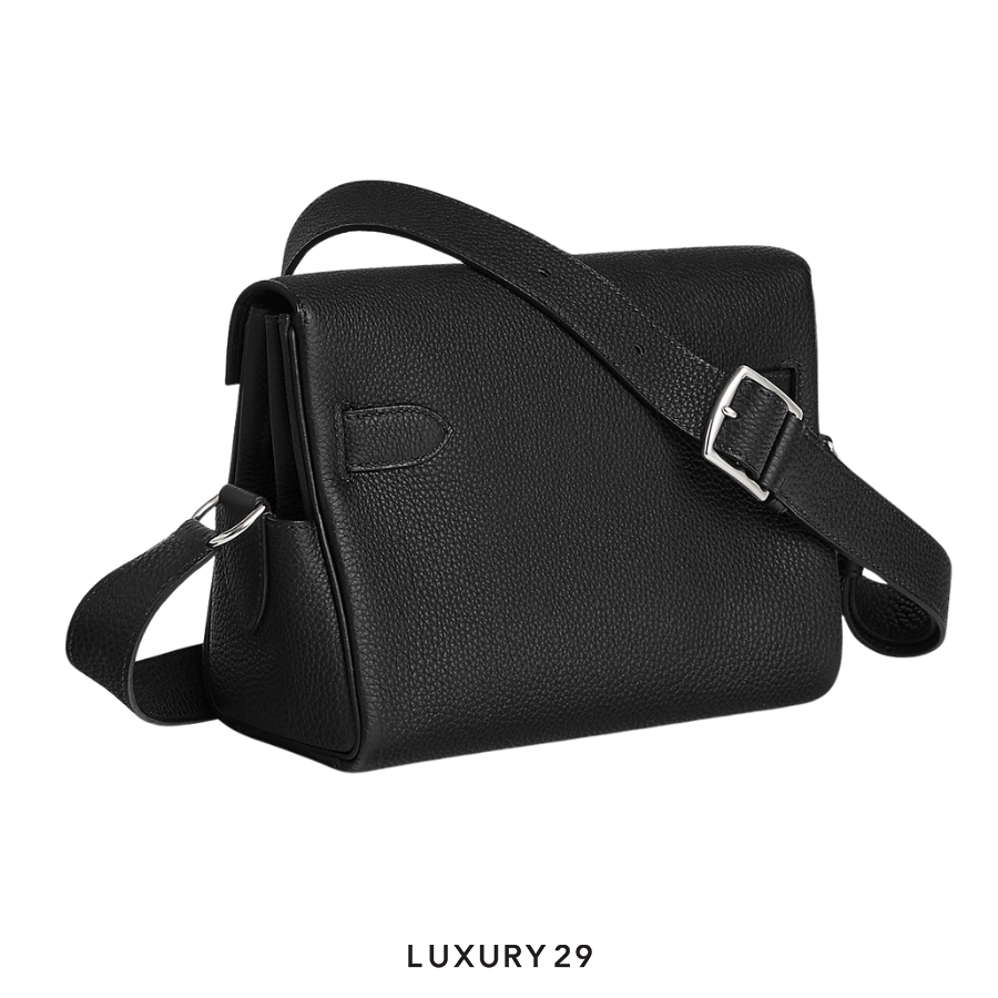 Black leather shoulder bag with a buckle on a white background