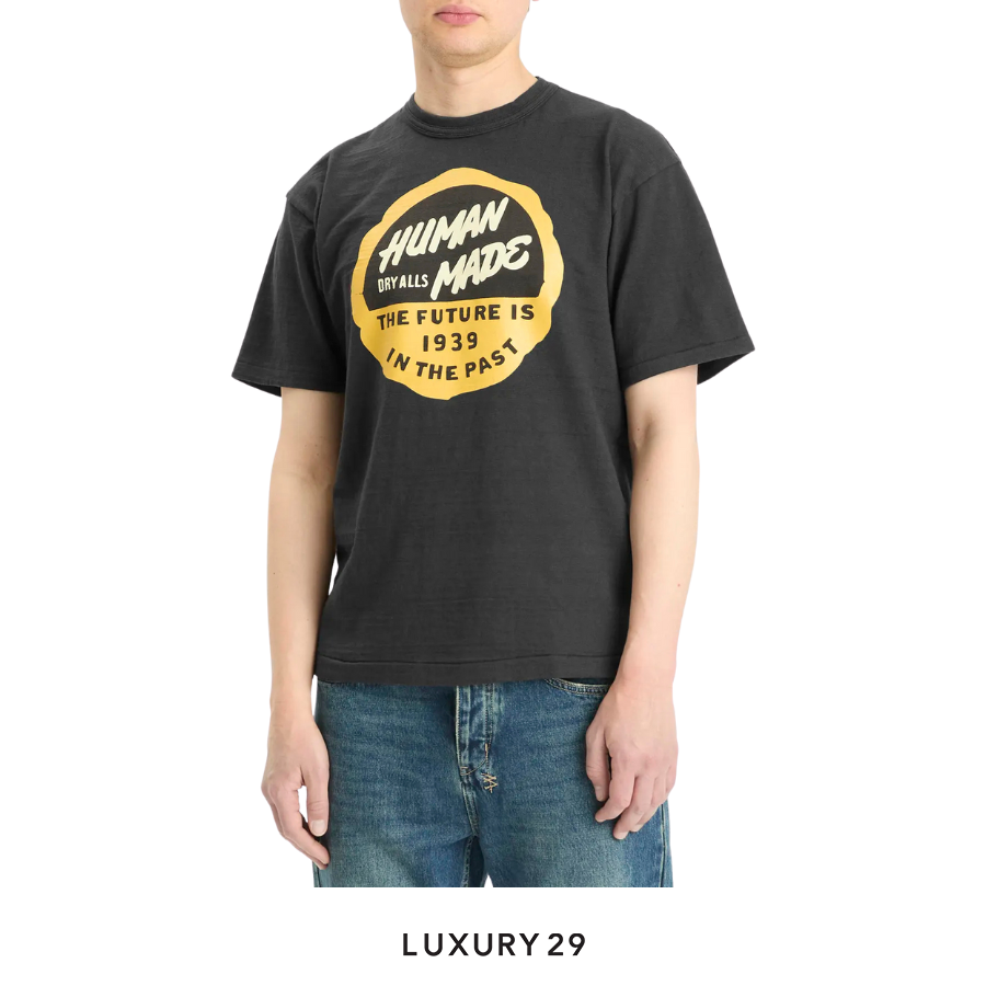 Person wearing a black t-shirt with yellow text and jeans on a white background