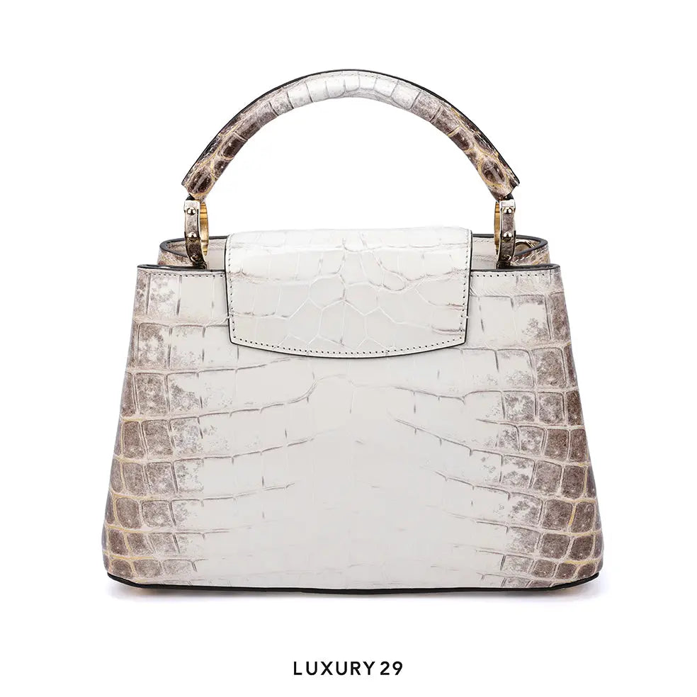 White textured handbag with brown accents on a white background