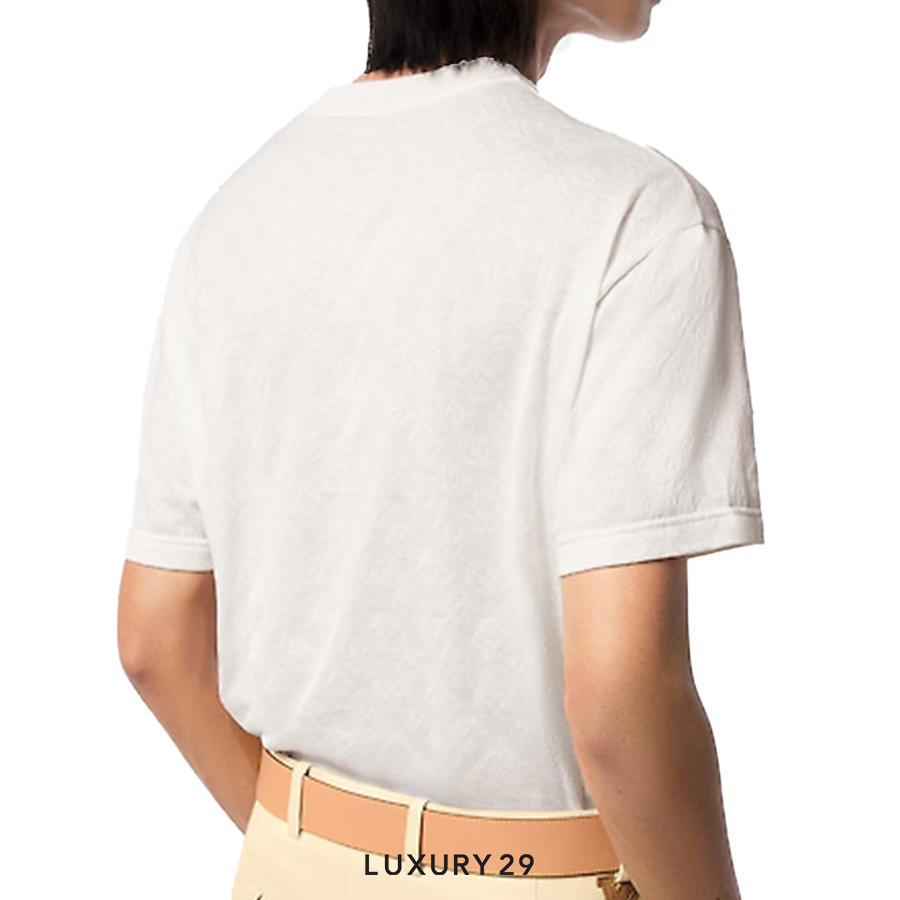 Person wearing a white t-shirt with 'LUXURY 29' belt visible