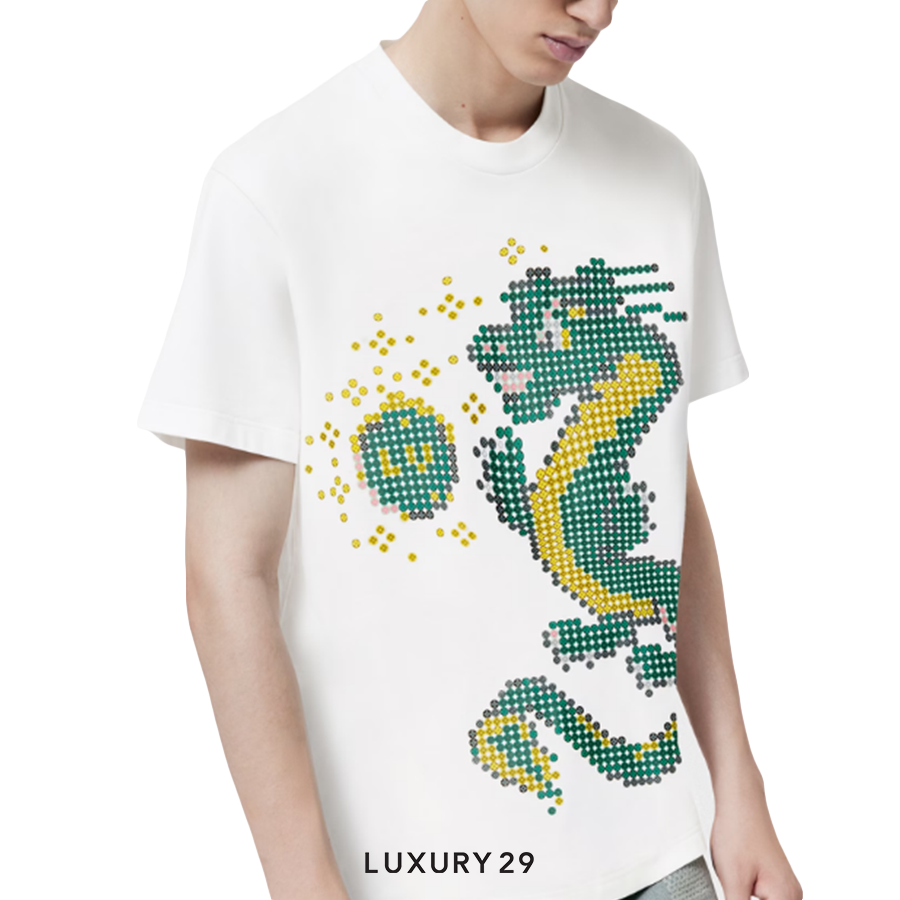 White t-shirt with a green and yellow dragon design worn by a person