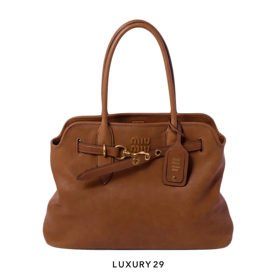 Brown leather handbag with gold hardware on a white background