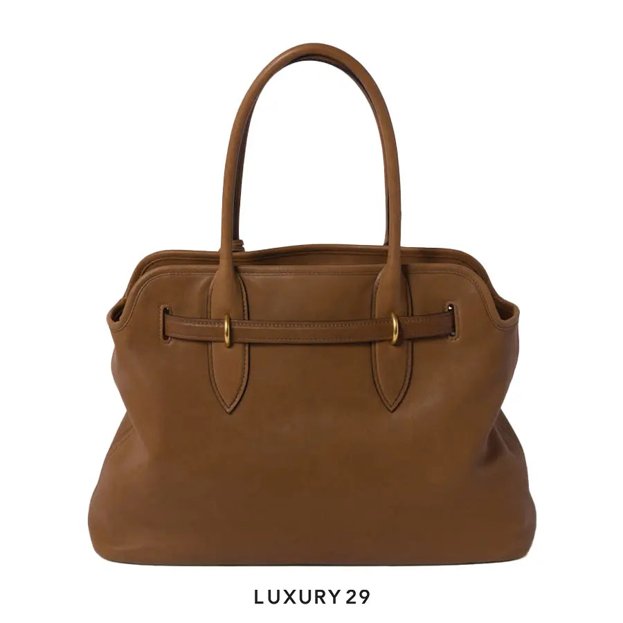 Brown leather handbag with gold accents on a white background