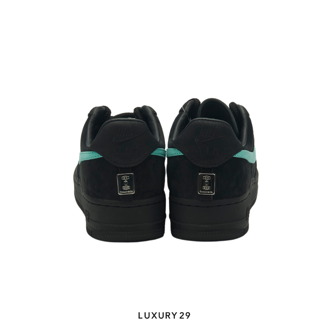 Black sneakers with green accents on a white background