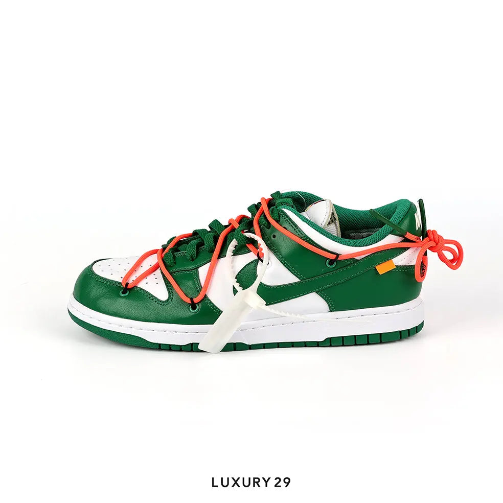 Green and white sneaker with orange laces on a white background