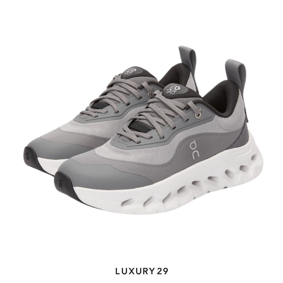 Gray running shoes with white sole on a white background